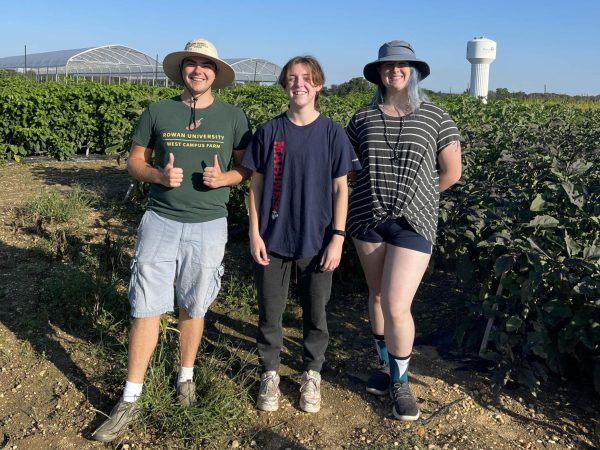 Brendan Birmingham joins Kristian Szymanski and Eva Sanko, the other student farmers, standing in front of the tomato tents. (Gianna Malgieri / The Whit)