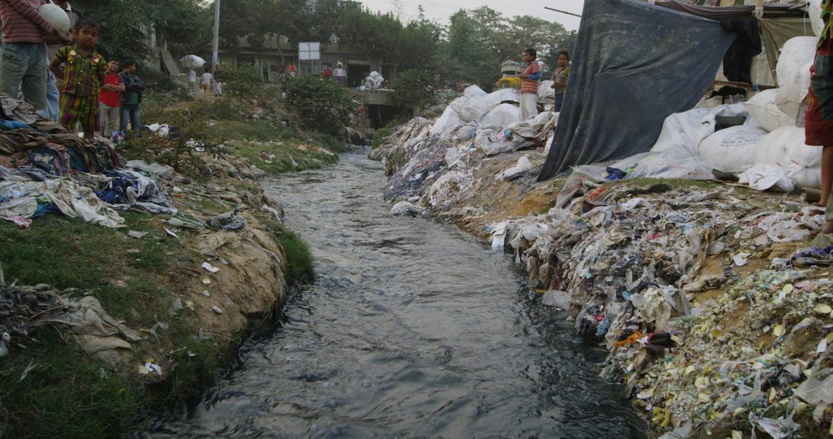 Polluted river near a clothing factory from the 2017 documentary RiverBlue.  (Roger Williams. Used with permission.)