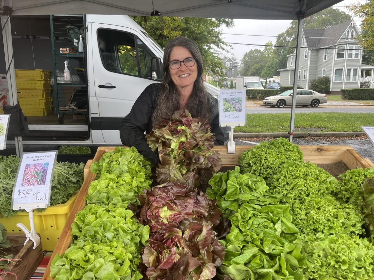 Carol Di Meo, co-owner of Savoie Organic Farm, holds up a head of lettuce at the Collingswood Farmers Market. Collingswood, New Jersey. Saturday, September 28, 2024. (Gavin Schweiger)